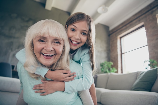 Little girl and grandmother sitting on the couch