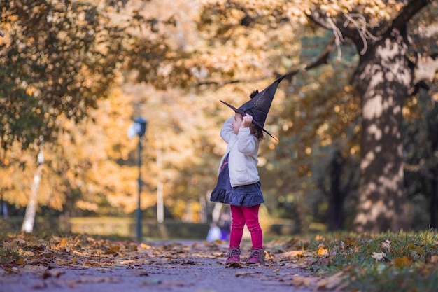 Little girl in halloween forest child playing in autumn park kids pick ripe vegetables on a farm in