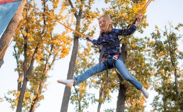 Little girl having fun on jumping rope