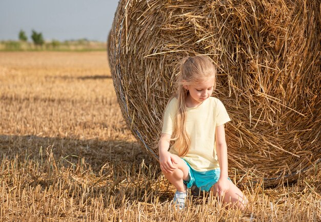 Little girl having fun in a wheat field on a summer day