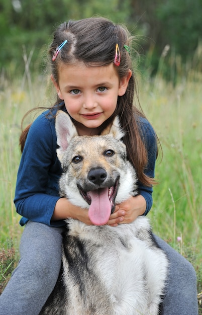 Little girl and her baby wolf dog