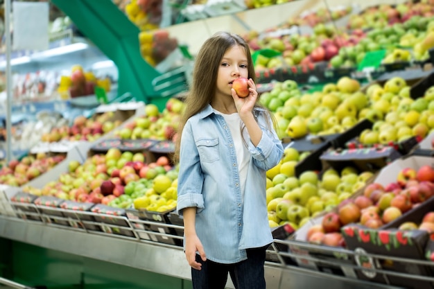 Little girl holding an apple