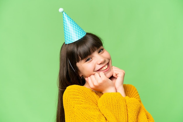 Little girl holding birthday cake over isolated chroma key background