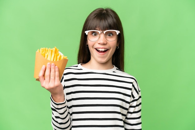 Little girl holding fried chips over isolated chroma key background