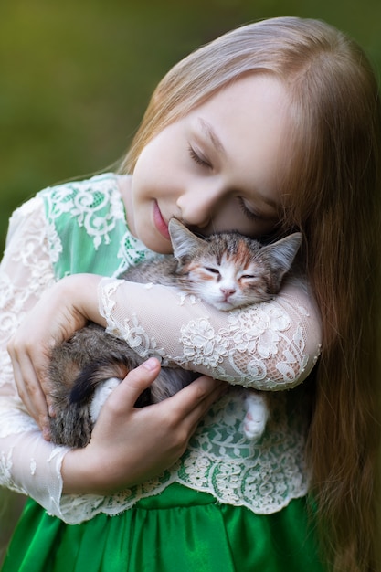 little girl holding a kitten