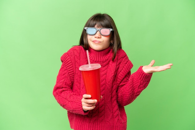 Little girl holding soda over isolated chroma key background having doubts while raising hands