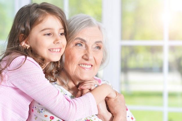 Little girl hugging grandmother