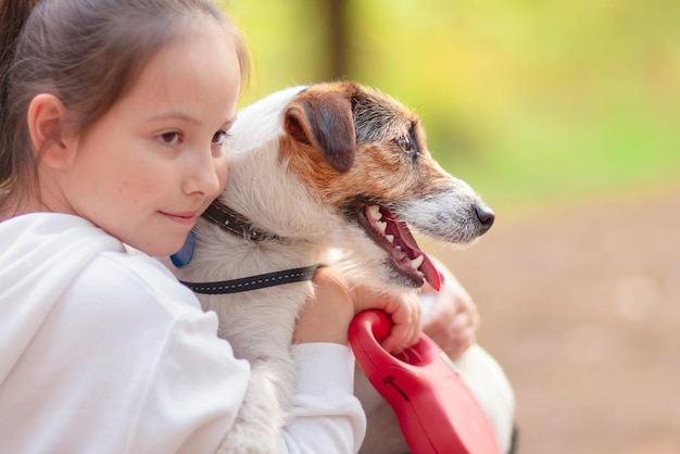 Little girl hugging her dog