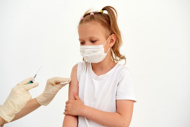 A little girl is afraid of vaccinations injections and vaccinations The child is being vaccinated against the coronavirus