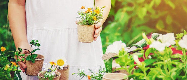 A little girl is planting flowers The young gardener Selective focus