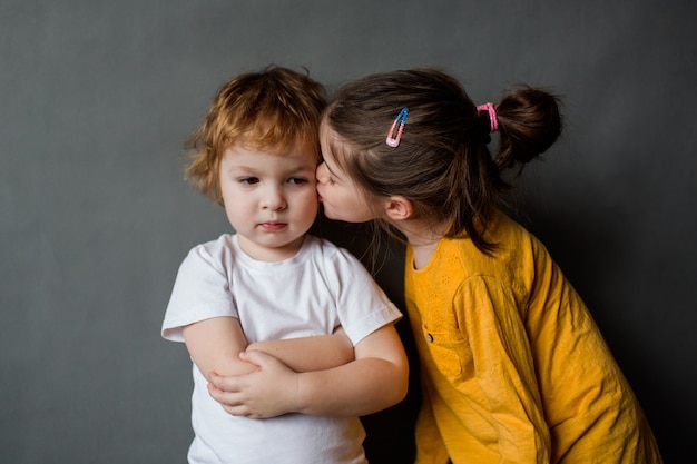 little girl kisses little boy