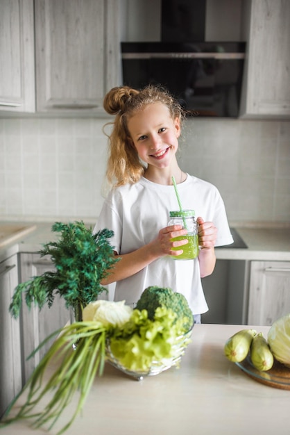 Little girl the kitchen Green fresh vegetables and salad healthy food