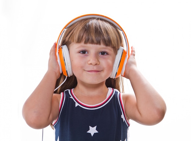 little girl listen music with headphone