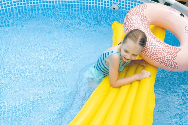 Little Girl Lying on Pool Float