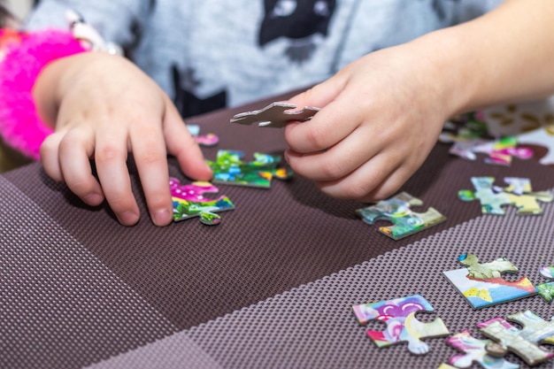 A little girl makes puzzles Educational games for children