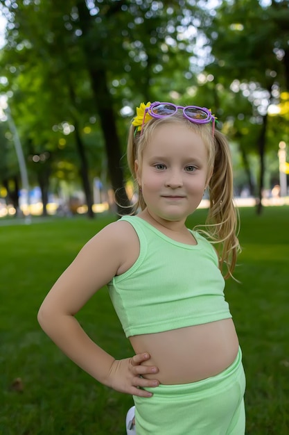 Little girl model in front of the camera posing in the park