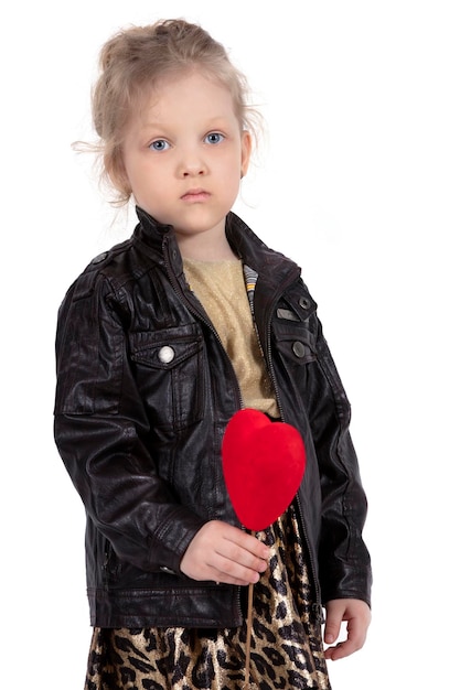 Little girl model Sad child with a red heart Beautiful five year old baby