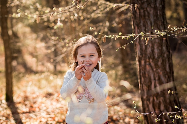 little girl on nature examines plants