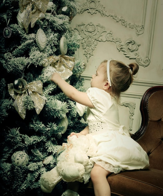 Little girl near cristmass tree holiday picture