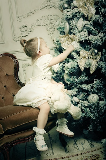 Little girl near cristmass tree