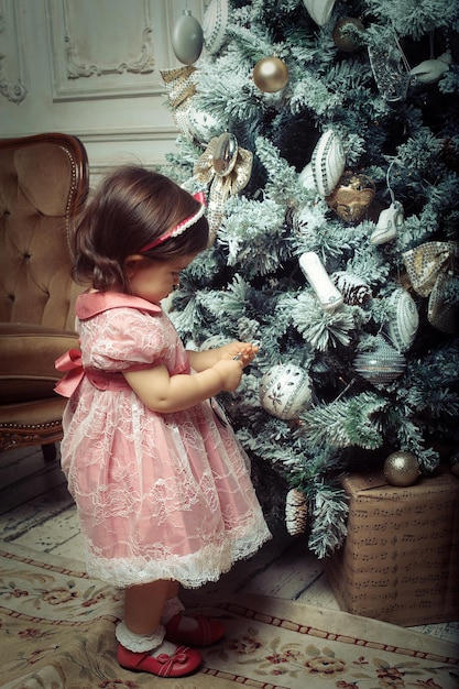 Little girl near cristmass tree