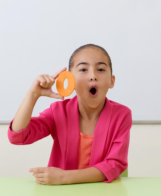 Little girl in office training correct pronunciation practicing different sounds