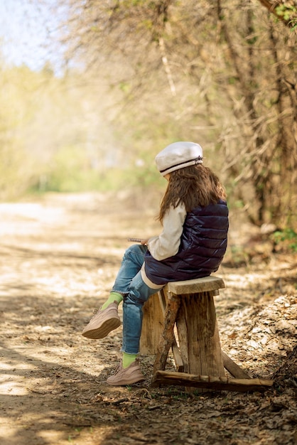 Little girl paints in open air in spring blooming fairytale park Children39s drawings Creative kid Joy of childhood