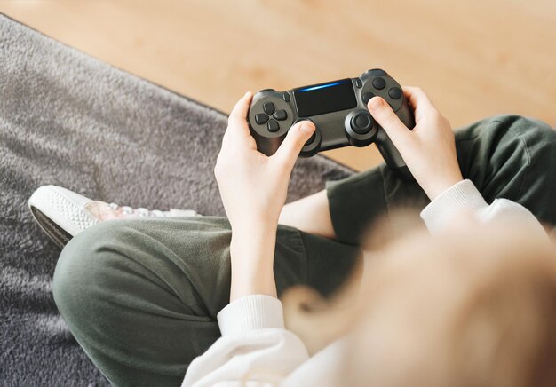 Little girl playing on games console