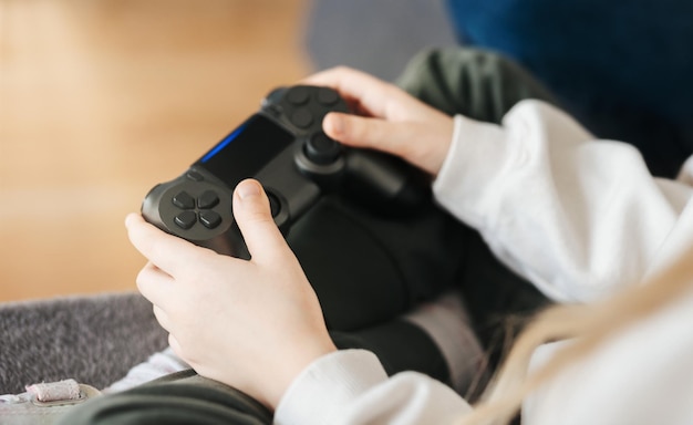 Little girl playing on games console