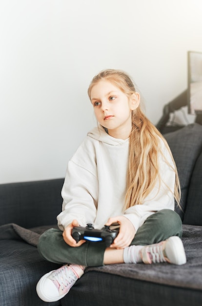 Little girl playing on games console