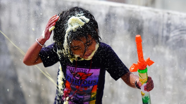 A little girl playing holi wity water and colors