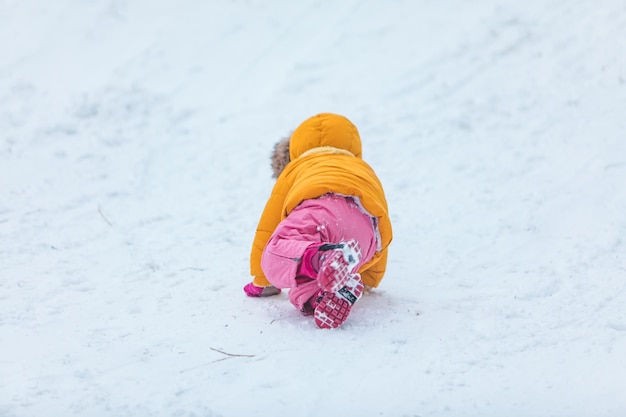 Little girl playing outdoors in snow