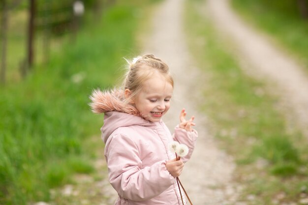 A little girl playing outside on an autumn day