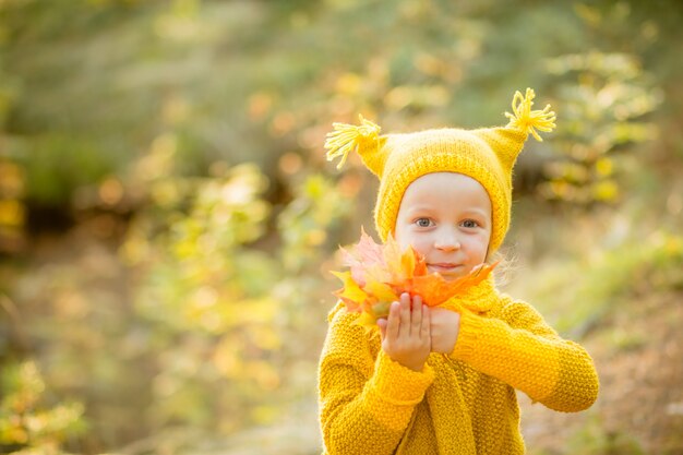 Little girl playing on sunny autumn day