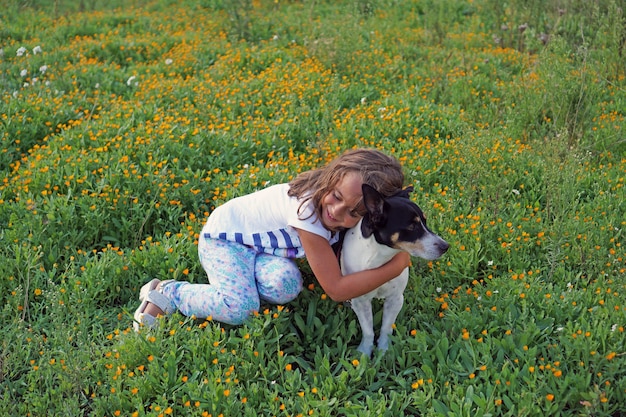 Little girl playing with jack russell terrier