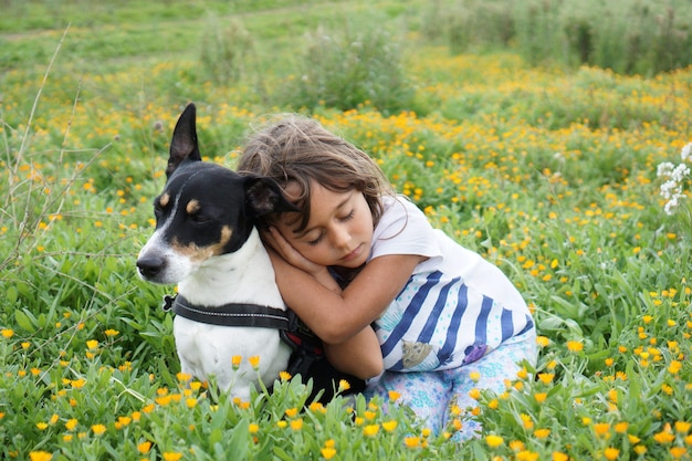 Little girl playing with jack russell terrier