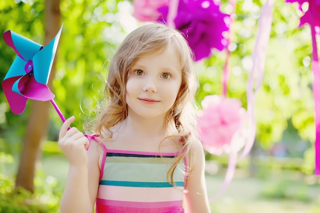 Little girl posing  on the children&#39;s holiday outdoors