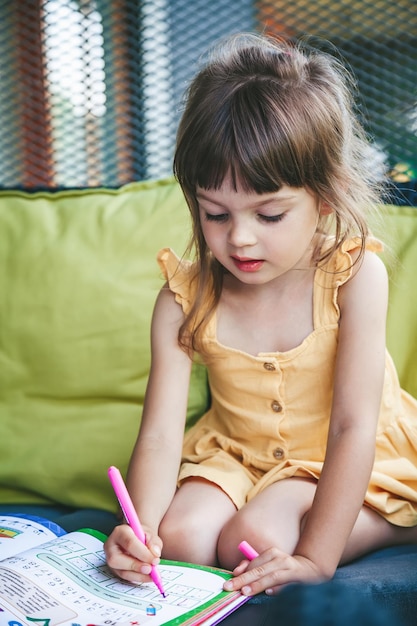 Little girl preschooler studying at home