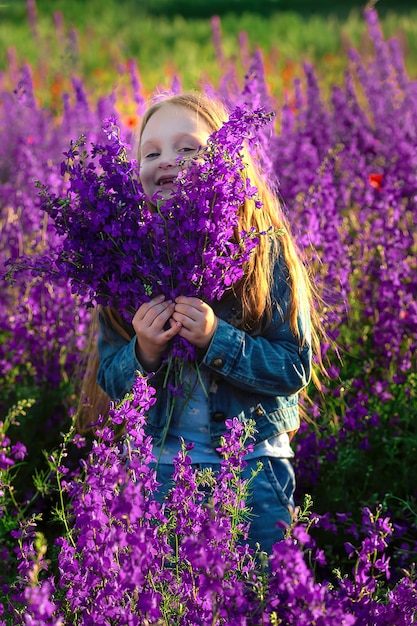 Little girl preschooler with a bouquet of wildflowers