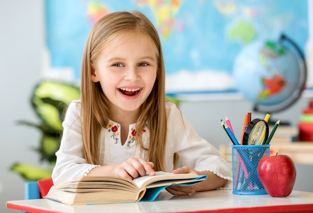 Little girl reading book