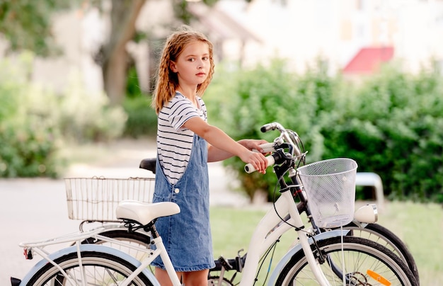 Little girl rides a kick scooter