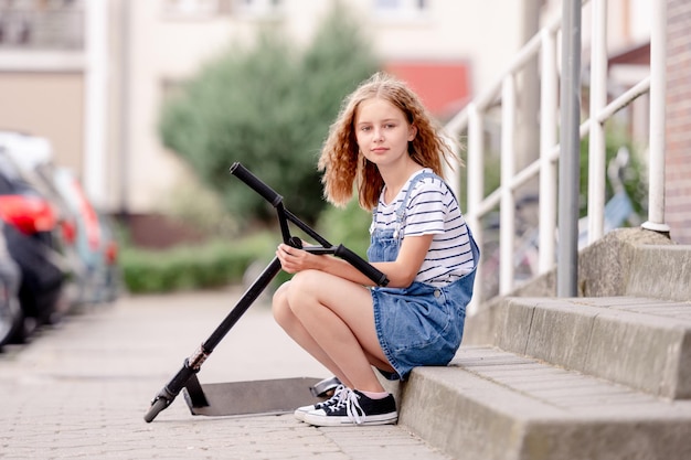 Little girl rides a kick scooter