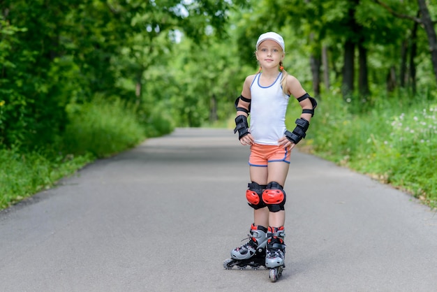 Little girl in roller skates at a park