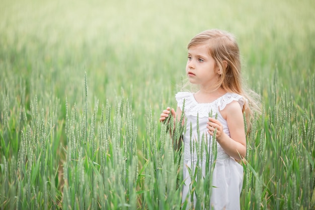 Little girl running in country field in summer