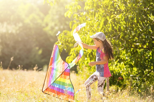 little girl running outdoor with a kite