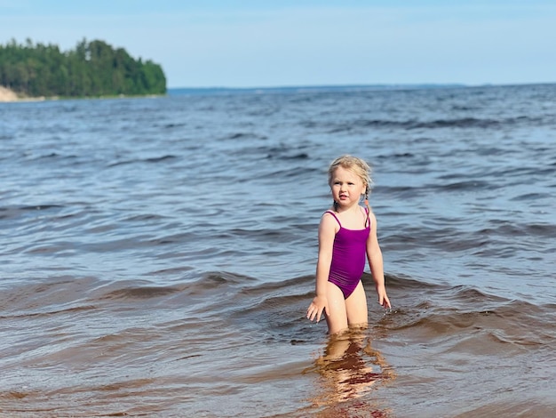 Little girl running with splashes in sea