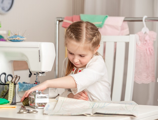 Little girl in a sewing workshop