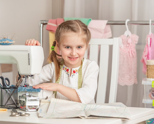 Little girl in a sewing workshop