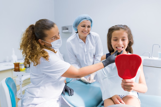 Little girl sitting on a chair at the dentist