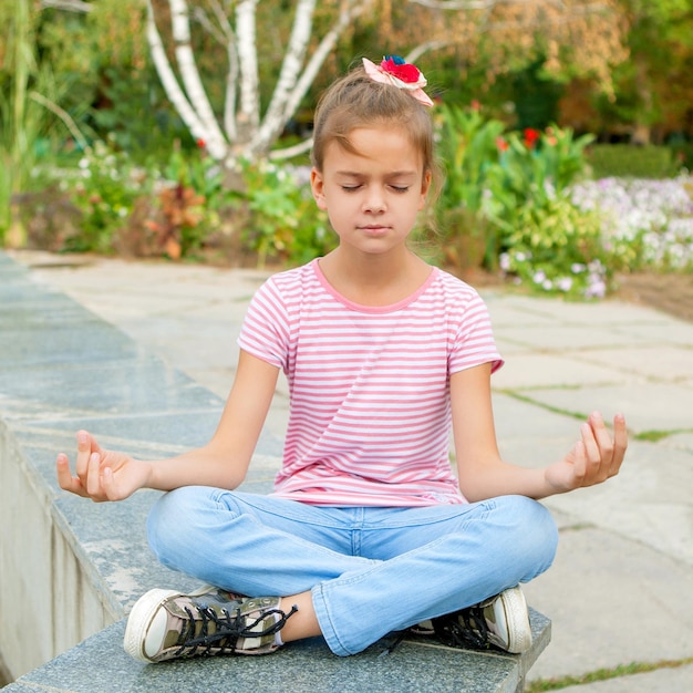 Little girl sitting in yoga pose